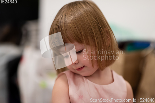 Image of portrait of little girl playing at home