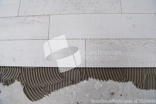 Image of Ceramic wood effect tiles and tools for tiler on the floor