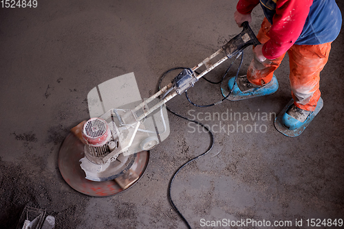 Image of worker performing and polishing sand and cement screed floor