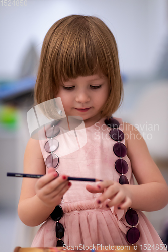 Image of little girl painting jewelry box