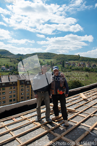 Image of Construction worker installing a new roof