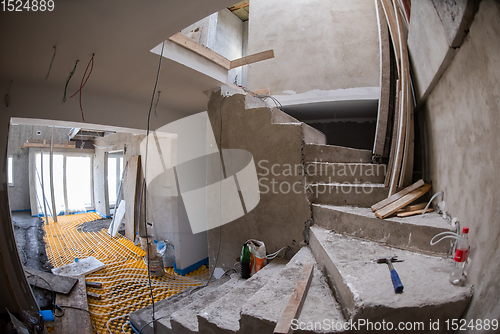 Image of yellow underfloor heating installation with white pipes