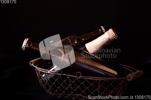 Image of beer bottles on a black background chiaroscuro in an old metal m