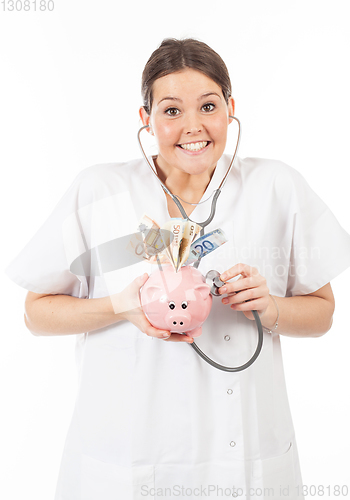 Image of happy woman doctor with piggy bank full of money