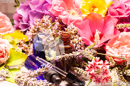 Image of flowers and bottles of essential oils for aromatherapy