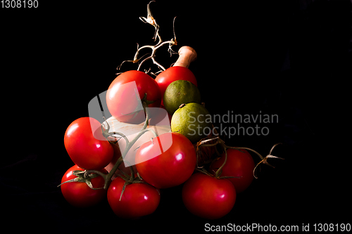 Image of large red and ripe tomatoes with a mortar and pestle in olive wo