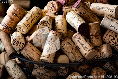 Image of old cork stoppers of French wines in a wire basket