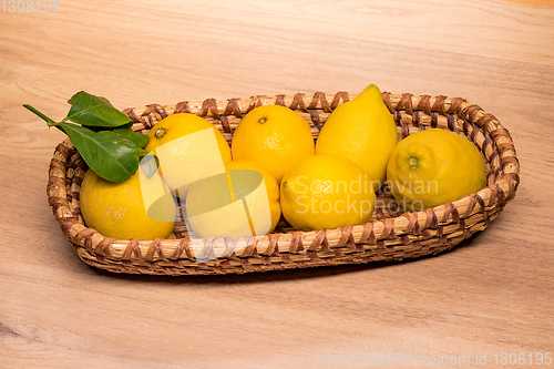 Image of yellow lemons in a small wooden basket