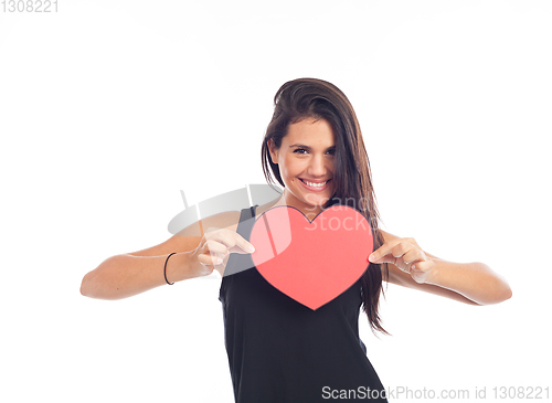 Image of beautiful happy young woman who is holding a big red heart for v