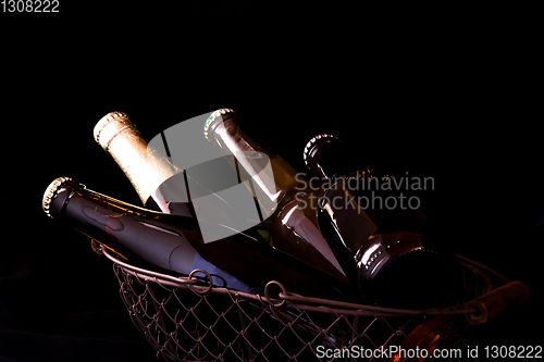 Image of beer bottles on a black background chiaroscuro in an old metal m