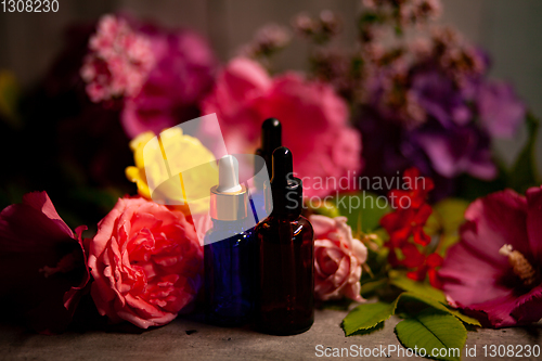 Image of flowers and bottles of essential oils for aromatherapy