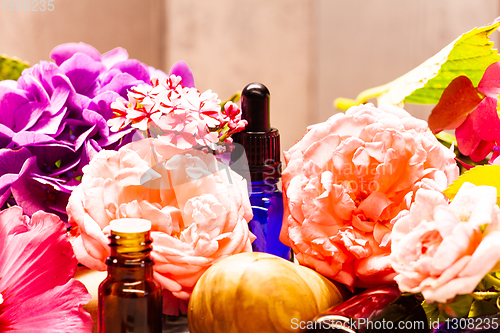 Image of flowers and bottles of essential oils for aromatherapy