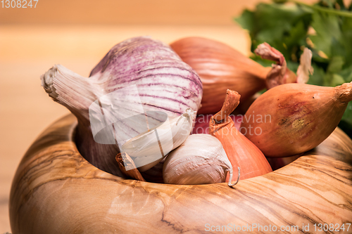 Image of garlic onion shallot parsley with pestle and olive wood mortar