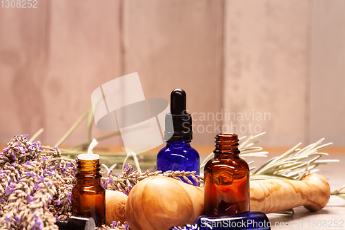 Image of lavender mortar and pestle and bottles of essential oils for aro