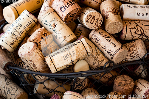 Image of old cork stoppers of French wines in a wire basket