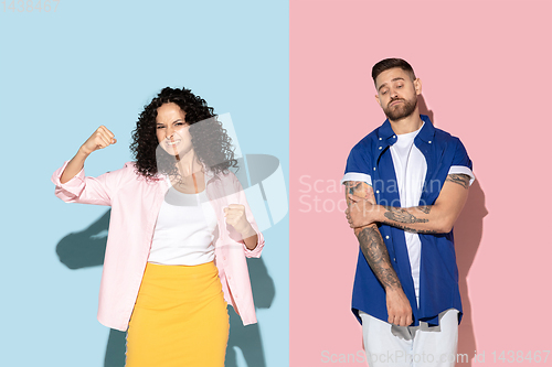 Image of Young emotional man and woman on pink and blue background