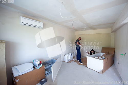 Image of professional plumber working in a bathroom