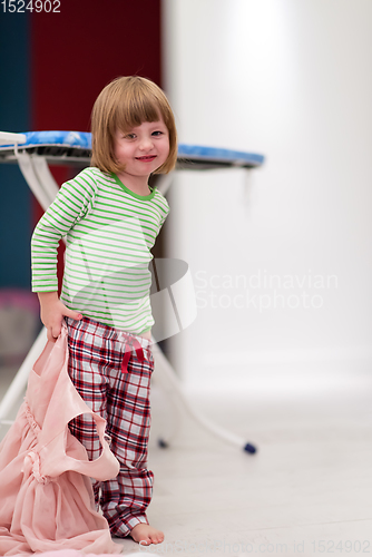 Image of portrait of cute little girl playing at home