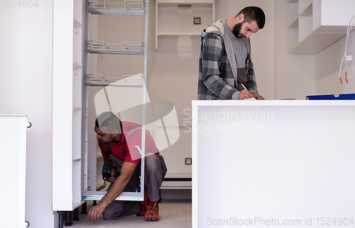 Image of workers installing a new kitchen