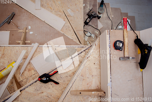 Image of work in progress on stylish interior with wooden stairs