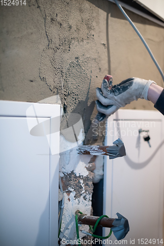 Image of Worker plastering the wall by concrete