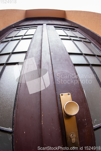 Image of Close up outdoor view of an old wooden double door