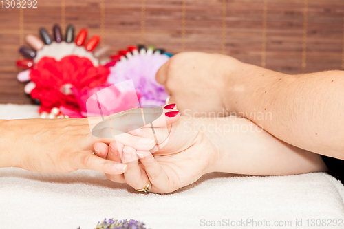 Image of Applying nail polish on a woman\'s hands