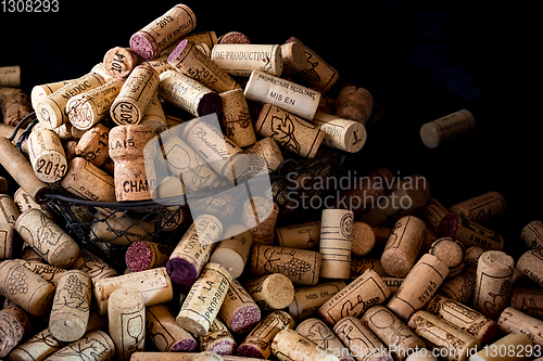 Image of old cork stoppers of French wines in a wire basket