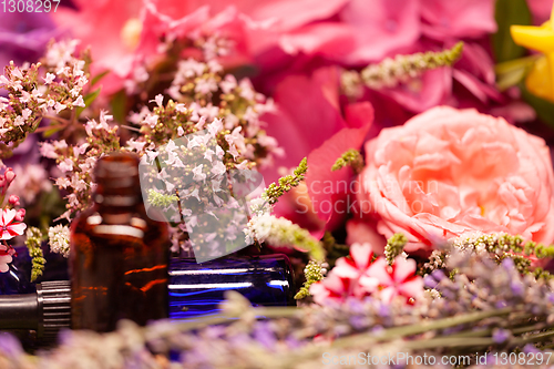 Image of flowers and bottles of essential oils for aromatherapy