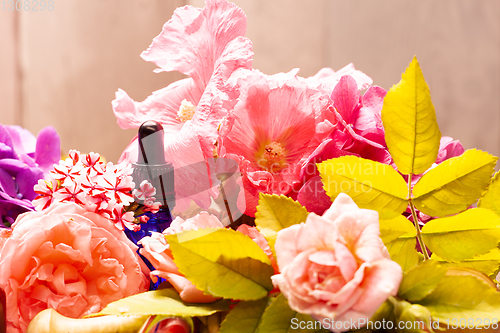 Image of rose flowers and bottles of essential oils for aromatherapy