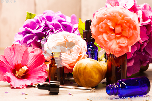 Image of flowers and bottles of essential oils for aromatherapy