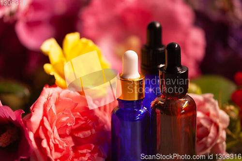 Image of flowers and bottles of essential oils for aromatherapy