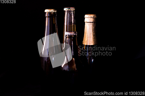 Image of beer bottles on a black background in bright dark