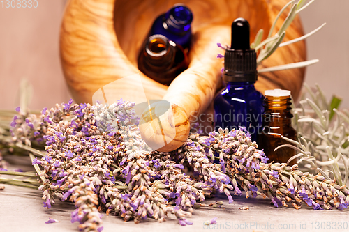 Image of lavender mortar and pestle and bottles of essential oils for aro