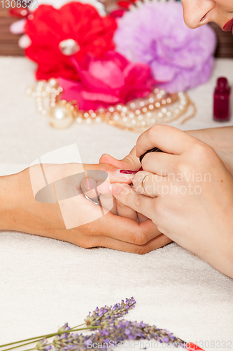 Image of Applying nail polish on a woman\'s hands
