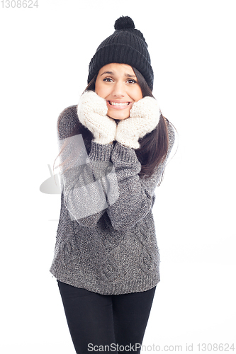 Image of pretty brunette woman with a woolen hat a sweater and gloves tha