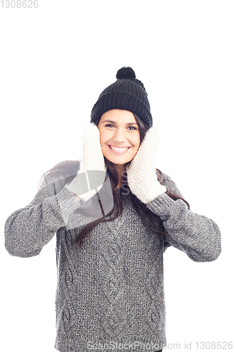 Image of pretty brunette woman with a woolen hat a sweater and gloves smi