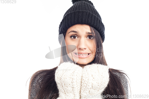 Image of pretty brunette woman with a woolen hat a sweater and gloves tha