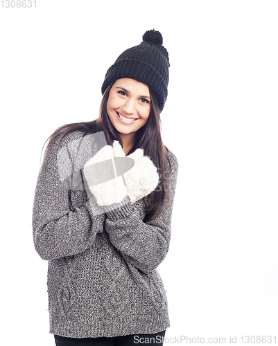 Image of pretty brunette woman with a woolen hat a sweater and gloves smi