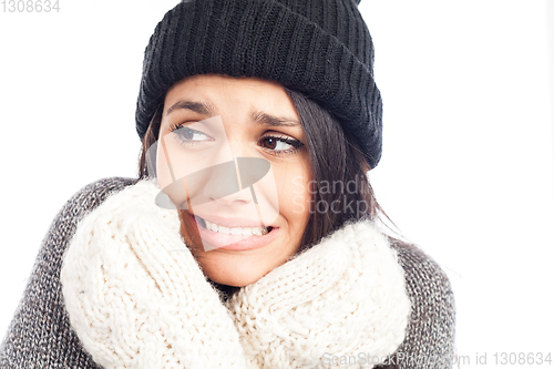 Image of pretty brunette woman with a woolen hat a sweater and gloves tha