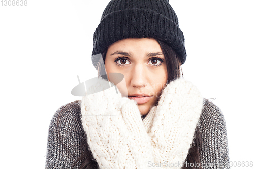 Image of pretty brunette woman with a woolen hat a sweater and gloves tha