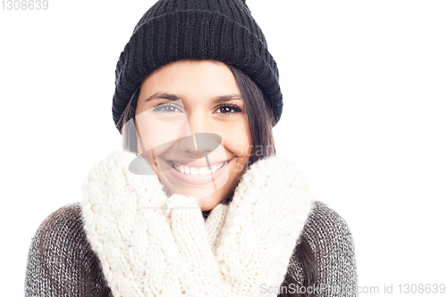 Image of pretty brunette woman with a woolen hat a sweater and gloves tha