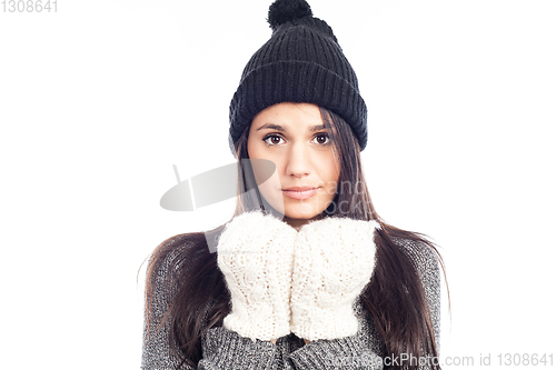 Image of pretty brunette woman with a woolen hat a sweater and gloves tha