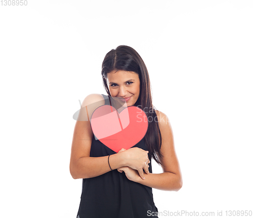 Image of beautiful happy young woman who is holding a big red heart for v