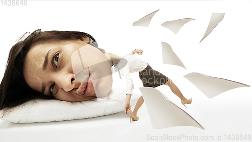 Image of Big head on small body lying on the pillow