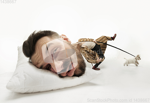 Image of Big head on small body lying on the pillow