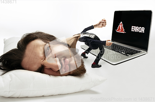 Image of Big head on small body lying on the pillow