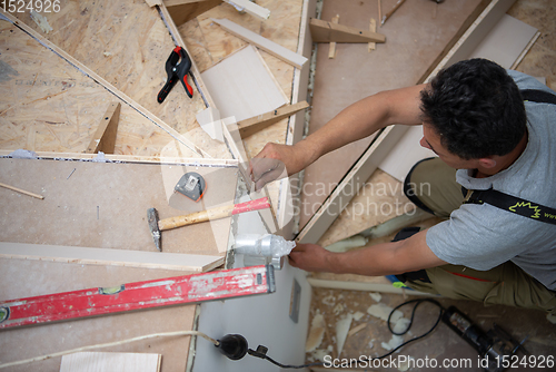 Image of carpenter installing wooden stairs