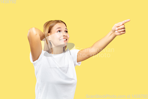 Image of Caucasian young woman\'s half-length portrait on yellow background