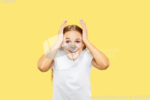 Image of Caucasian young woman\'s half-length portrait on yellow background